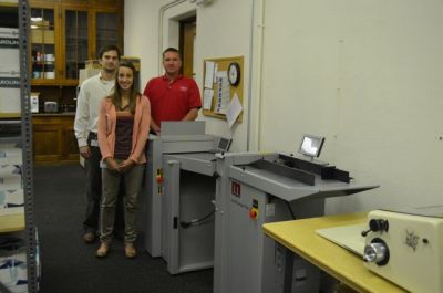 From left: Matt Roper, Taylor Hartung and Tom Weiser show off Franklin University Printing Services’ new Morgana Auto­Fold Pro and AutoCreaser Pro 33, which, along with a new Neopost AS-950C color inkjet printer, are the latest pieces of equipment to arrive at this one-year-old in-plant.