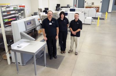 Print Shop Supervisor Larry Mills (left) stands with Pattie Paulsen and Doug Williams in Regional Health Printing Services’ new 7,300-square-foot facility. The new Xerox Color J75 Press is visible in the background.