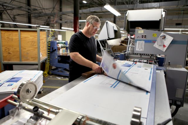 Leonard Pflugrad at the MBO Navigator folder, which is busy folding a 16-page signature in preparation for binding.